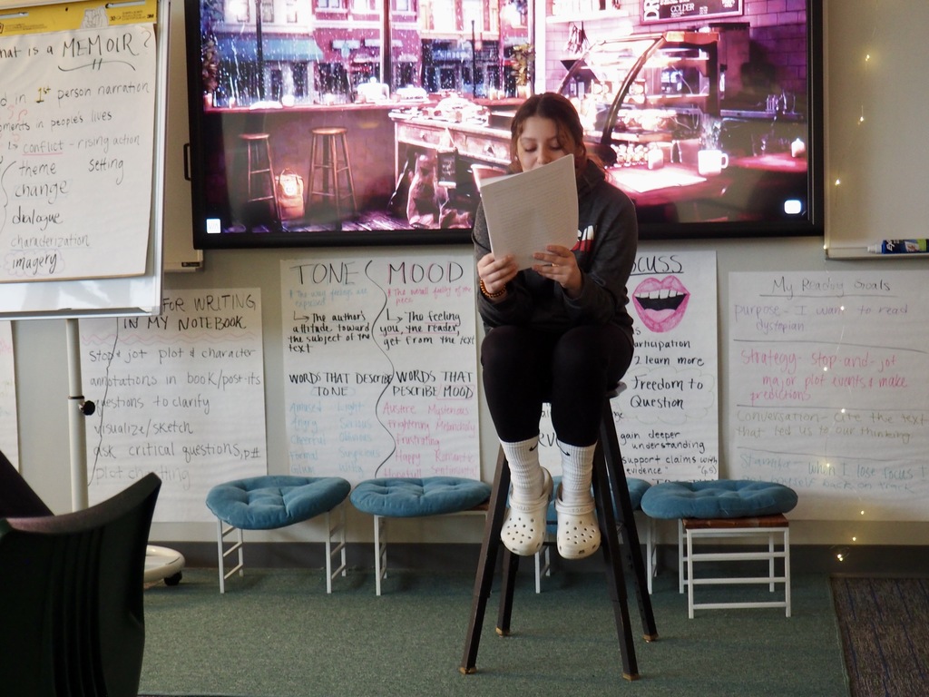 a student presents her memoir in front of the class