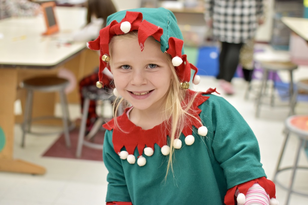 1st grade student in elf themed pajamas
